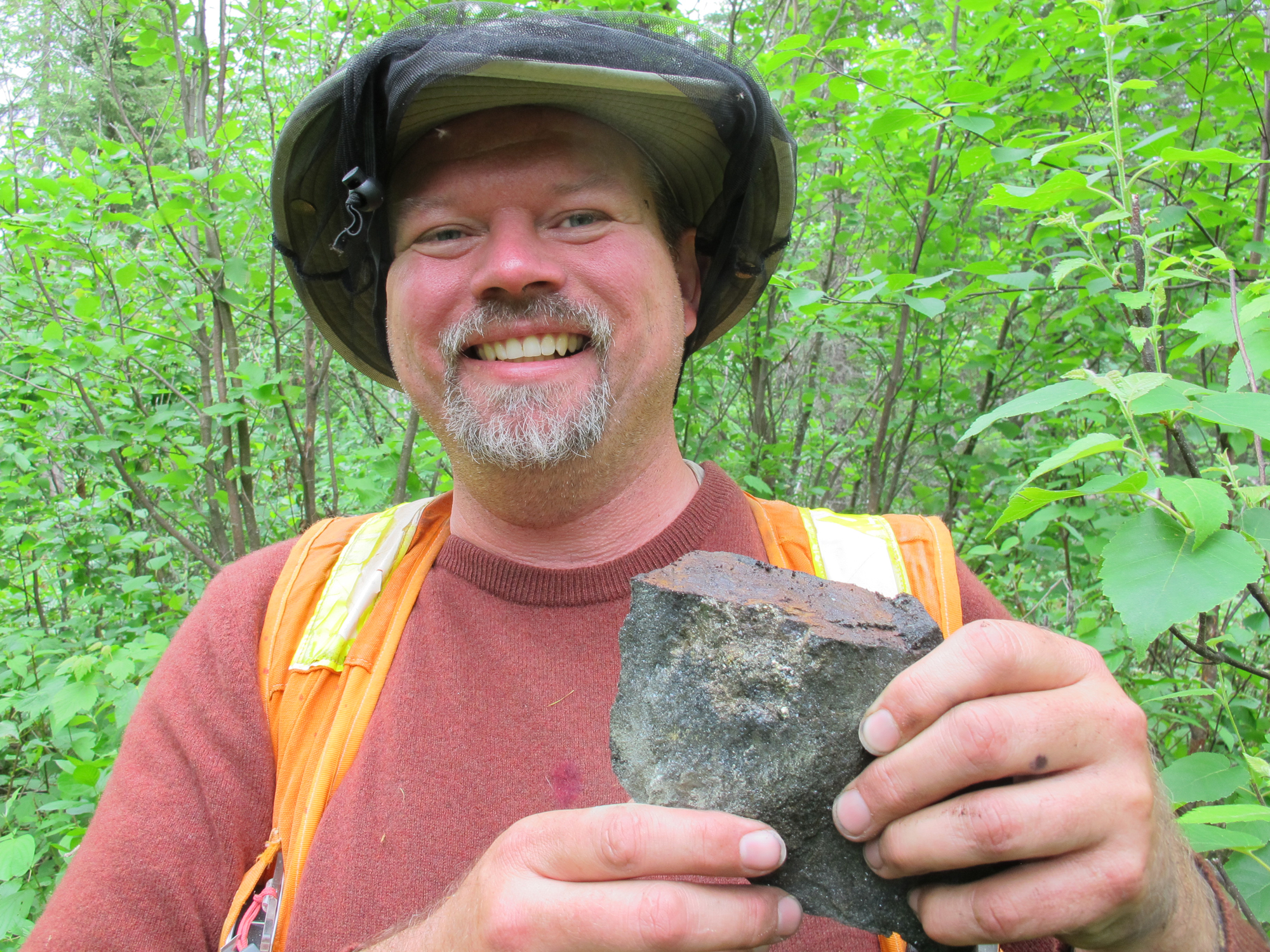 Neil Pettigrew, our VP of Exploration, holding up a field sample from Smoke Lake